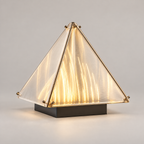 Lit pyramid desk lamp with translucent panels and dark rectangular base