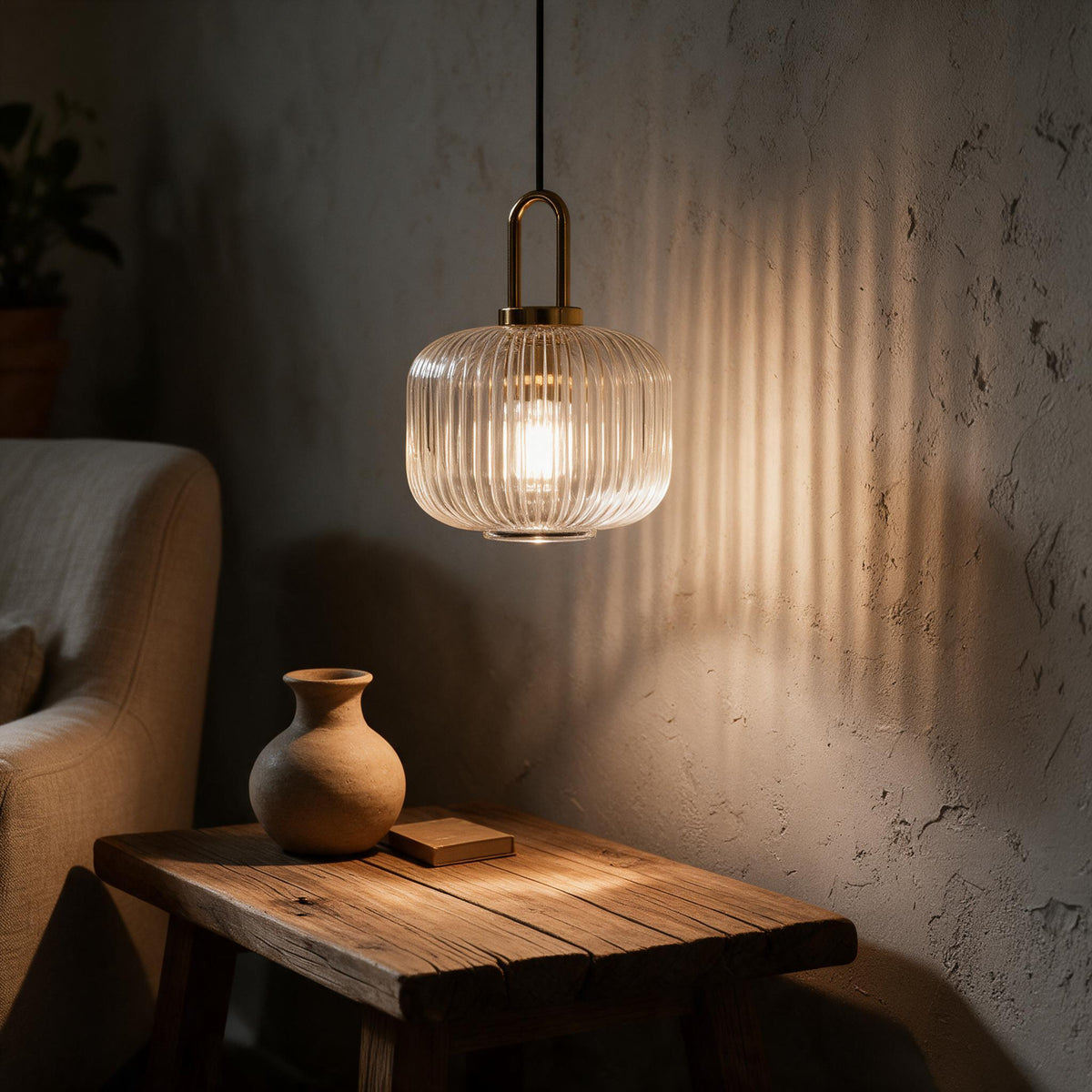 Striped blown-glass pendant shade lit from within, showing vertical banding