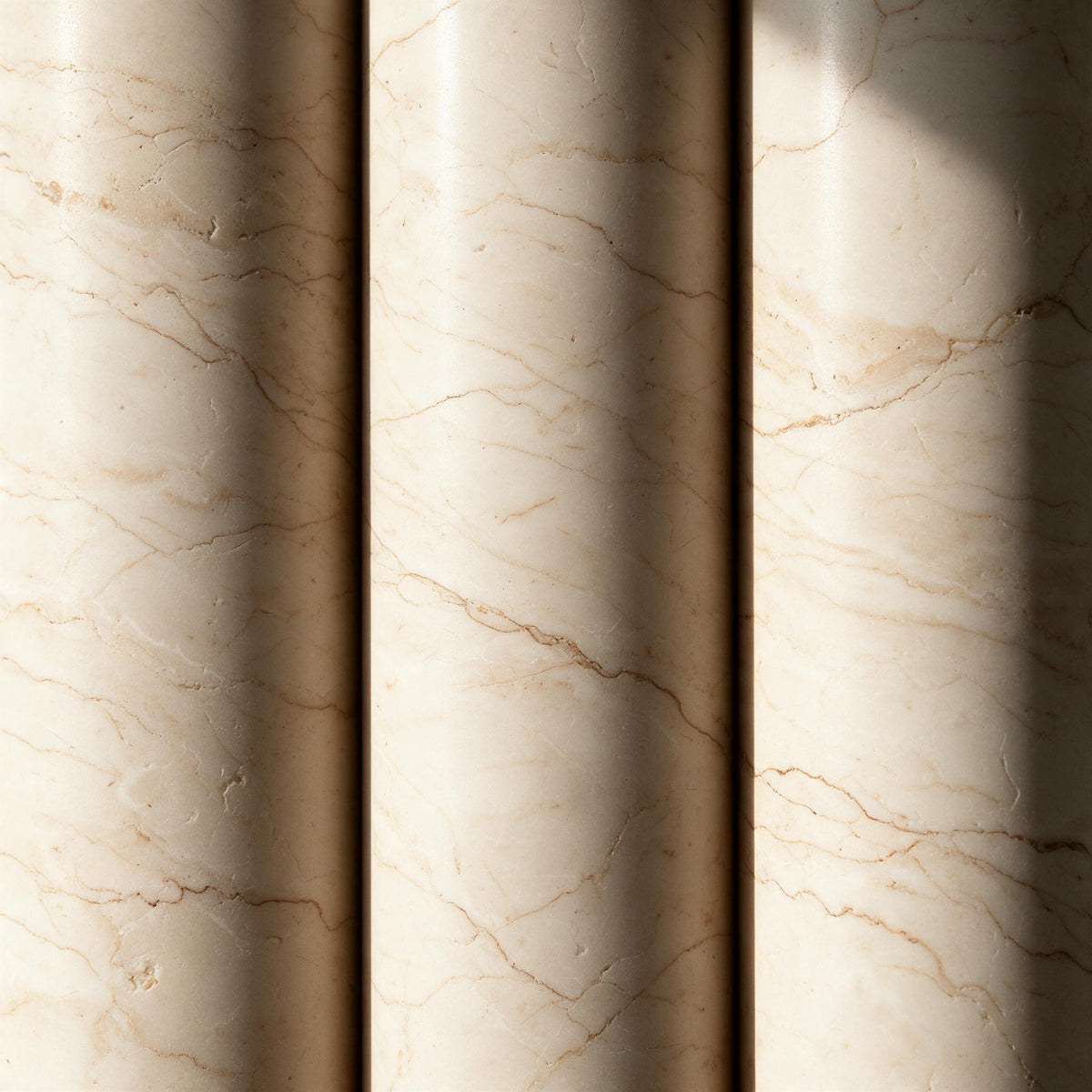 Close-up of the honed travertine pendant shade showing its smooth surface and natural mineral veining.