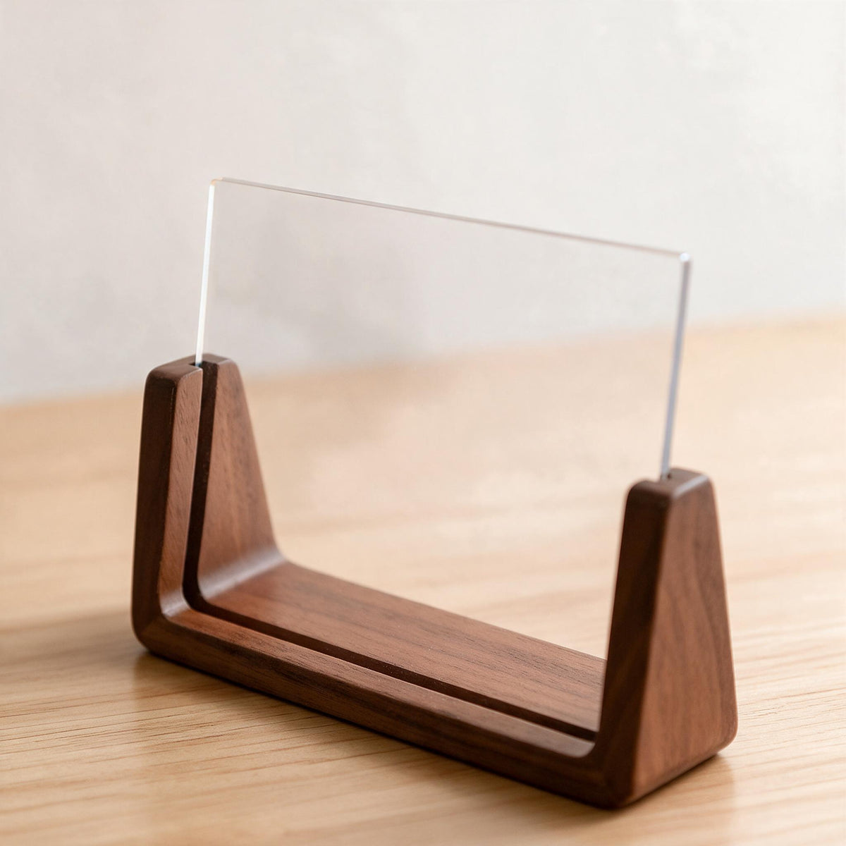 The U-shaped wood base photo frame standing upright on a shelf without extra support.