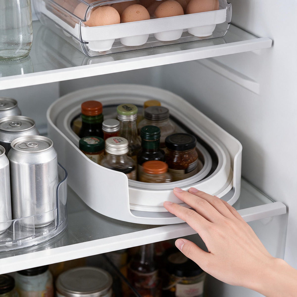 Oval rotating refrigerator organizer with bottles arranged on the carousel