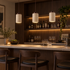 Variant D tall travertine pendant lights with dark wood caps above a home bar
