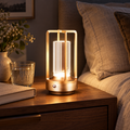 Rechargeable dimmable Golden acrylic LED table lamp on a moody bedroom nightstand