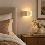 Cream French resin wall sconce providing warm bedside lighting
