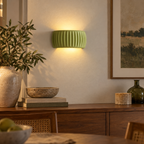 Green French resin wall sconce above a dining room sideboard