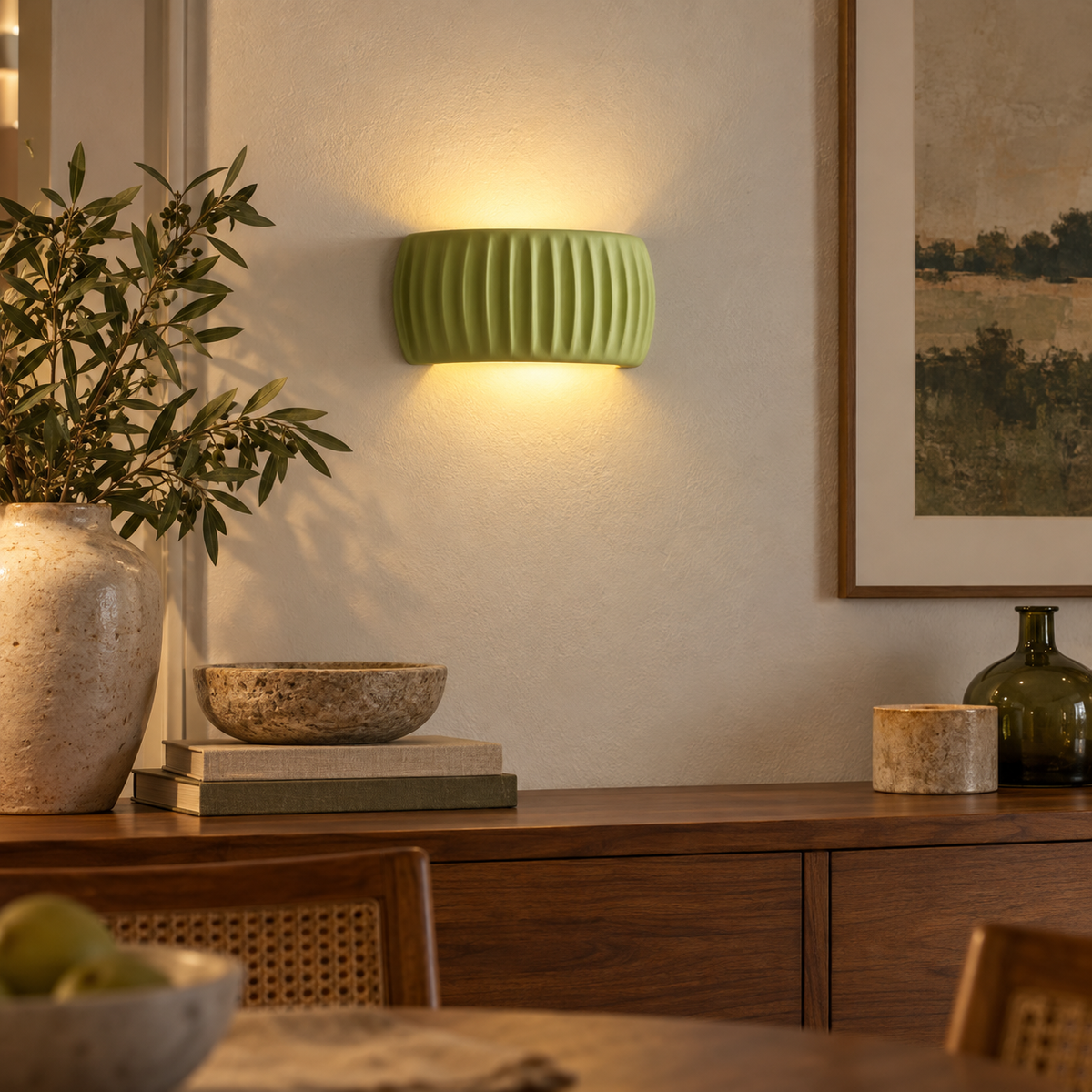Green French resin wall sconce above a dining room sideboard