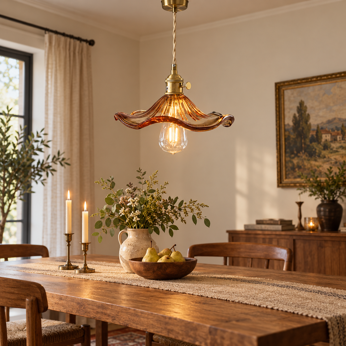 Amber glass and antique brass pendant light above an intimate dining table
