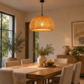 Handwoven bamboo and rattan pendant light above a warm wood dining table