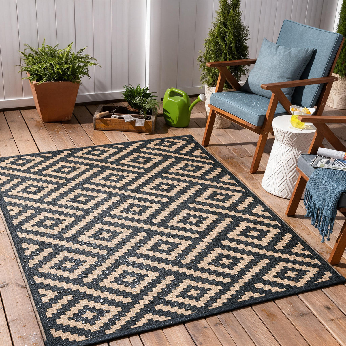 Boho geometric patterned outdoor rug laid flat on a patio.