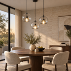 Transparent double-glass pendant lights above a modern round dining table