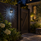 Snowman cool white solar mandala fence lamp beside a garden gate