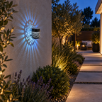 Snowman cool white solar mandala fence lamp illuminating a garden walkway