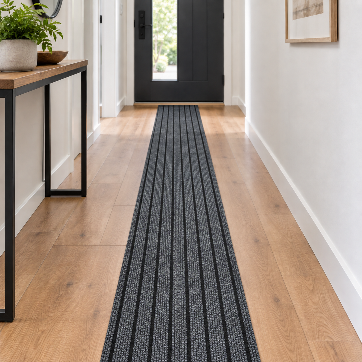 Black and gray striped self-adhesive floor runner in a modern hallway