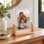Light wood 5x7 portrait acrylic photo frame displaying a family picture on a console